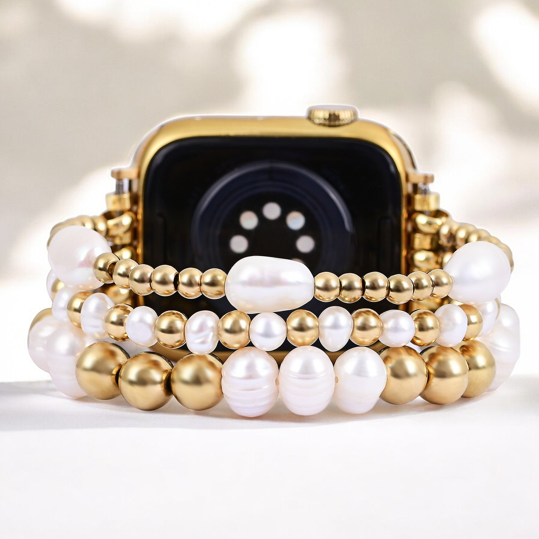 골드 및 펄 스트레치 Apple Watch 스트랩